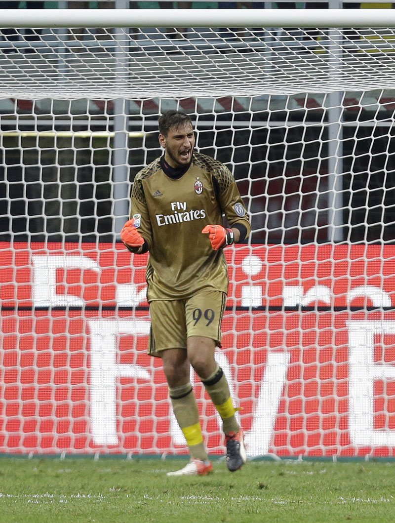 AC Milan goalkeeper Gianluigi Donnarumma celebrates after saving a penalty during the Serie A soccer match between AC Milan and Torino at the San Siro stadium in Milan, Italy, on Sunday, August 21, 2016. Bacca scored an hat-trick. Photo: AP