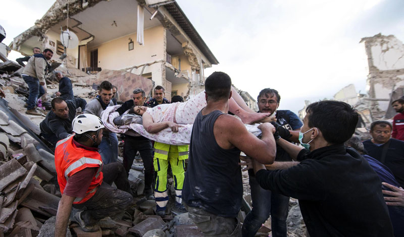 A rescued woman is carried away on a stretcher following an earthquake in Amatrice Italy, on Wednesday, August 24, 2016.  The magnitude 6 quake struck at 3:36 am (0136 GMT) and was felt across a broad swath of central Italy, including Rome where residents of the capital felt a long swaying followed by aftershocks. Photo: ANSA via AP