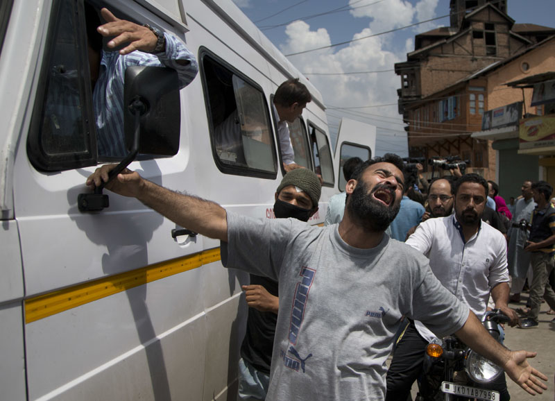 An unidentified relative of Riyaz Ahmad Shah, one among two civilians killed by government forces wails as an ambulance carrying his body arrives at his home in Srinagar,on Wednesday, Aug. 3, 2016. Photo: AP