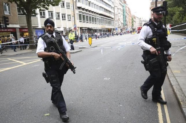 Armed police officers patrol at the scene of a knife attack in Russell Square in London, Britain August 4, 2016.   REUTERS/Neil Hall