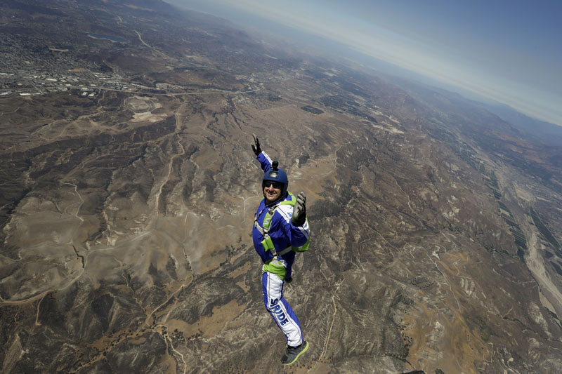 skydiver Luke Aikins smiles as he jumps from a helicopter during his training in Simi Valley, California, on Monday, July 25, 2016. Photo: AP