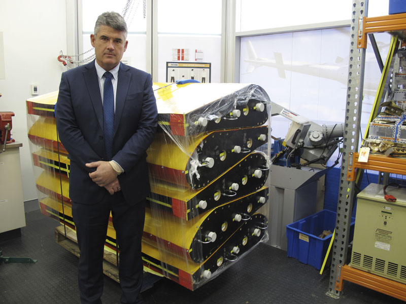 Peter Foley, Australian Transport Safety Bureau director of Flight 370 search operations, stands beside a stack of replica wing flaps on Thursday, on August 18, 2016, at the bureau's headquarters in Canberra, Australia. Photo: AP