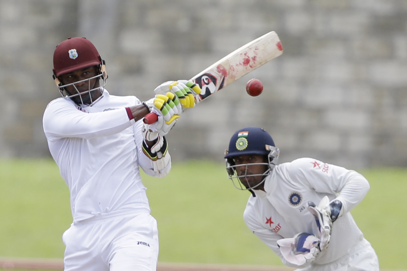 West Indies' batsman Marlon Samuels plays a shot bowled by India's Ravichandran Ashwin under the look of India's wicketkeeper Wriddhiman Saha during day four of their third cricket Test match at the Daren Sammy Cricket Ground in Gros Islet, St. Lucia, Friday, August 12, 2016. Photo: AP
