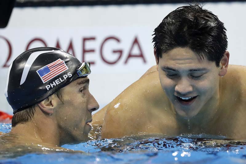 Singapore's Joseph Schooling is congratulated by United States' Michael Phelps after winning the gold medal in the men's 100-metre butterfly final during the swimming competitions at the 2016 Summer Olympics, on Friday, August 12, 2016, in Rio de Janeiro, Brazil. Photo: AP