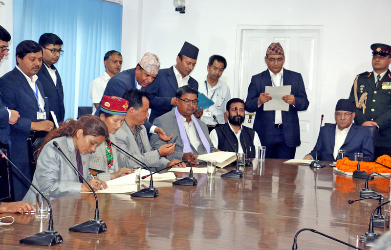 Newly appointed State Ministers (from left), Dhanamaya BK, Radhika Tamang, Satyanarayan Bhagat and Shree Prasad Jabegu sign the letter of oath at the OPMCM Singhadarbar, Kathmandu, on Sunday, August 14, 2016. Photo: RSS
