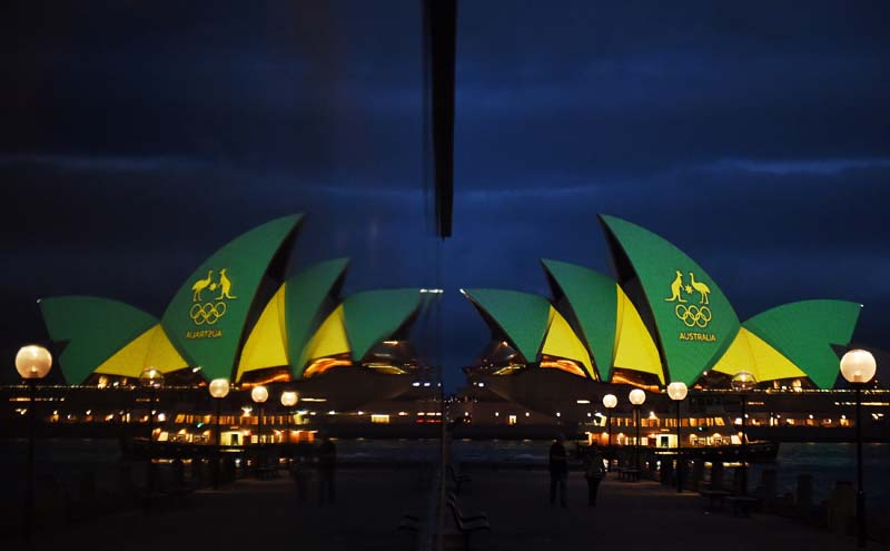 File- The Sydney Opera House is illuminated with the green and gold colours of the Australian Olympic team and reflected in a hotel window in Sydney, Australia, before the Olympics opening ceremony in Rio de Janeiro, Brazil, on August 5, 2016. Photo: Reuters