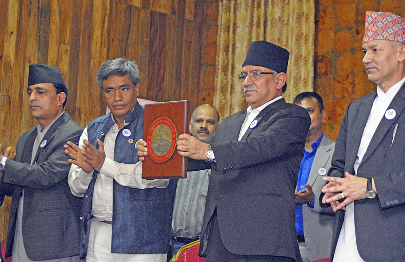 Prime Minister Pushpa Kamal Dahal unveiling the logo of National Information Commission at a special function organised to mark the 9th National Information Day, in Kathmandu, on Monday, August 22, 2016. Photo: THT