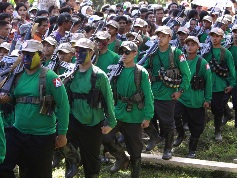 FILE - Communist New People's Army militants march in unison past local residents and supporters during the celebration of the 42nd anniversary of the Communist Party of the Philippines on Mount Diwata in southern Philippines, on December 26, 2010. Photo: AP