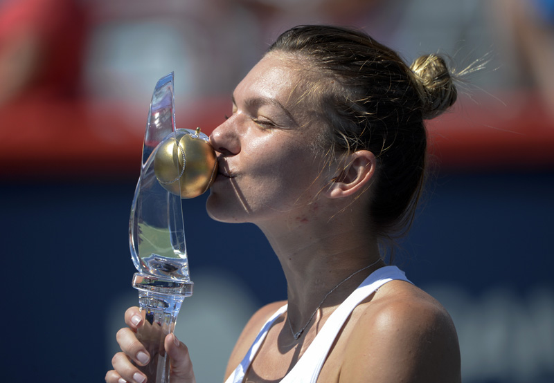 Simona Halep of Romania kisses the champions trophy after defeating Madison Keys of the United States (not pictured) during the final of the Rogers Cup tennis tournament at Uniprix Stadium in Montreal, Canada, on Sunday, July 31, 2016. Mandatory Credit: Eric Bolte-USA TODAY Sports