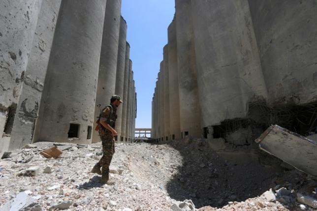 A Syria Democratic Forces (SDF) fighter walks in the silos and mills of Manbij after the SDF took control of it, in Aleppo Governorate, Syria, July 1, 2016. REUTERS/Rodi Said