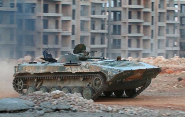 A fighter of the Syrian Islamist rebel group Jabhat Fateh al-Sham, the former al Qaeda-affiliated Nusra Front, rides in an armoured vehicle in the 1070 Apartment Project area in southwestern Aleppo, Syria August 5, 2016. REUTERS/Ammar Abdullah