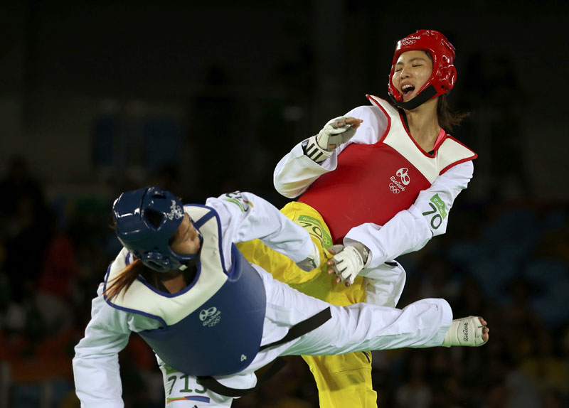 Taekwondo player Nisha Rawal (NEP) of Nepal competes with Zheng Shuyin (CHN) of China during the women's Taekwondo +67kg Preliminary round at Carioca Arena 3 in Rio de Janeiro, Brazil, on Saturday, August 20, 2016. Photo: Reuters