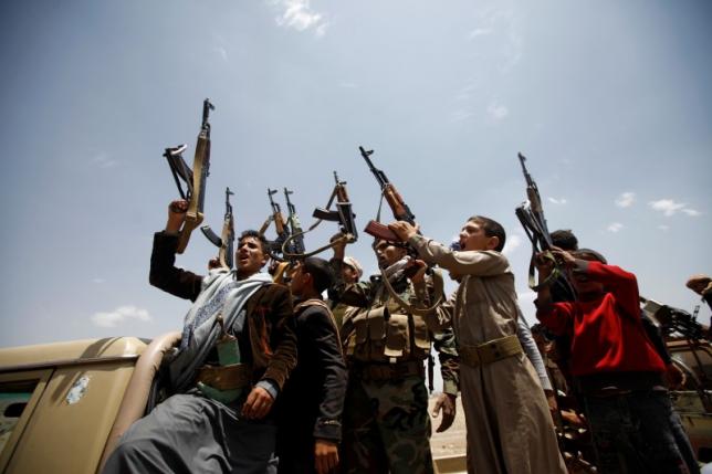 Houthi fighters react while riding on the back of a truck as they attend a tribal gathering in Sanaa, Yemen, July 16, 2016. REUTERS/Mohamed al-Sayaghi