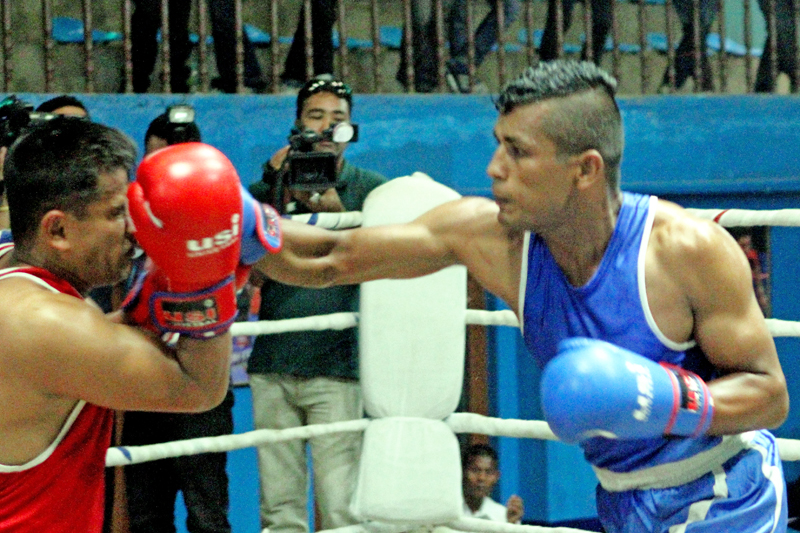 Manohar Basnet (right) of Lalitpur lands a punch on the face of Dhruba Ranabhat of TAC during their 81kg category final bout of the Inter-club Open Boxing Championship in Kathmandu on Monday, August 1, 2016. Photo: THT