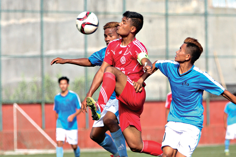 Tusal Youth Club skipper Sujit Gurung (centre) vies for the ball with Chyasal Youth Club players during their Martyrs Memorial B Division League match in Lalitpur on Friday, August 26, 2016. Photo: THT