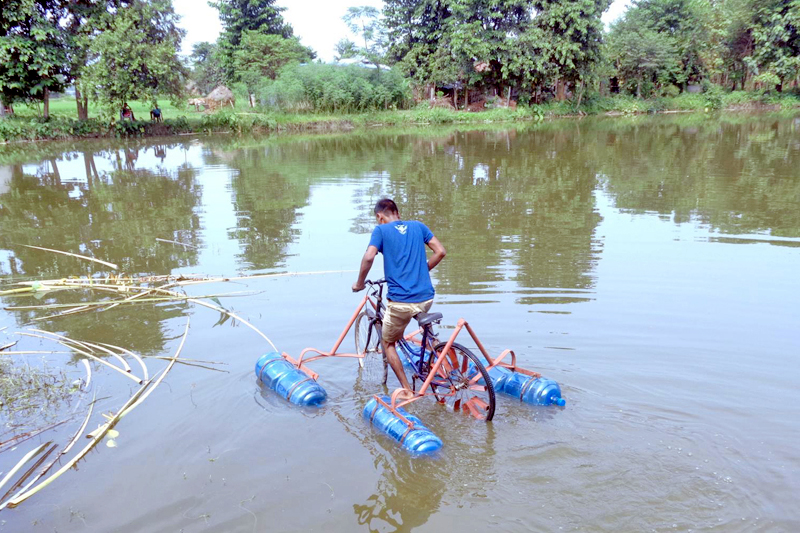 A man is seen pedalling a water bicycle on a pond in Morang district, on Tuesday, August 30, 2016. Photo: RSS