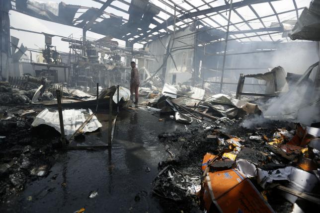 An employee walks inside a a snack food factory after a Saudi-led air strike hit it in Sanaa, Yemen, August 9, 2016. REUTERS/Khaled Abdullah