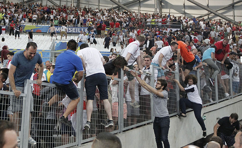 FILE- Spectators run on the stands as clashes break out right after the Euro 2016 Group B soccer match between England and Russia, at the Velodrome stadium in Marseille, France, on Saturday, June 11, 2016. ufeffufeffPhoto: AP