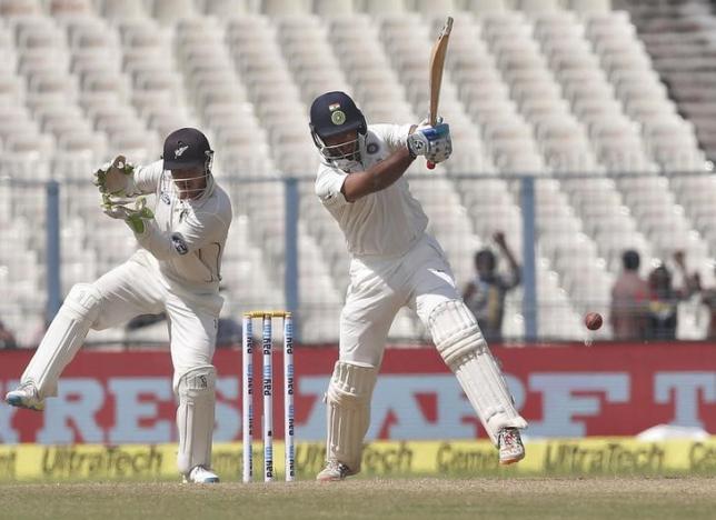 Cricket - India v New Zealand - Second Test cricket match - Eden Gardens, Kolkata - 30/09/2016. India's Cheteshwar Pujara (R) plays a shot past New Zealand's wicketkeeper Bradley-John Watling. REUTERS/Rupak De Chowdhuri