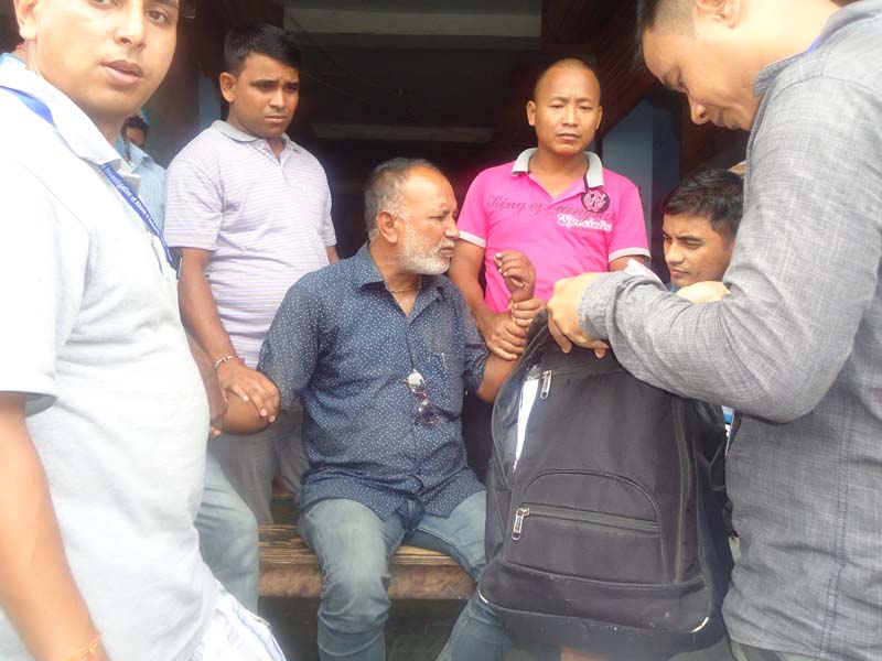 A team from the Commission for the Investigation of Abuse and Authority nabs the Secretary of Bathnaha VDC, Gulab Chaudhary, in Mahottari district red-handed while taking bribe on Thursday, September 8, 2016. Photo: Brij Kumar Yadav