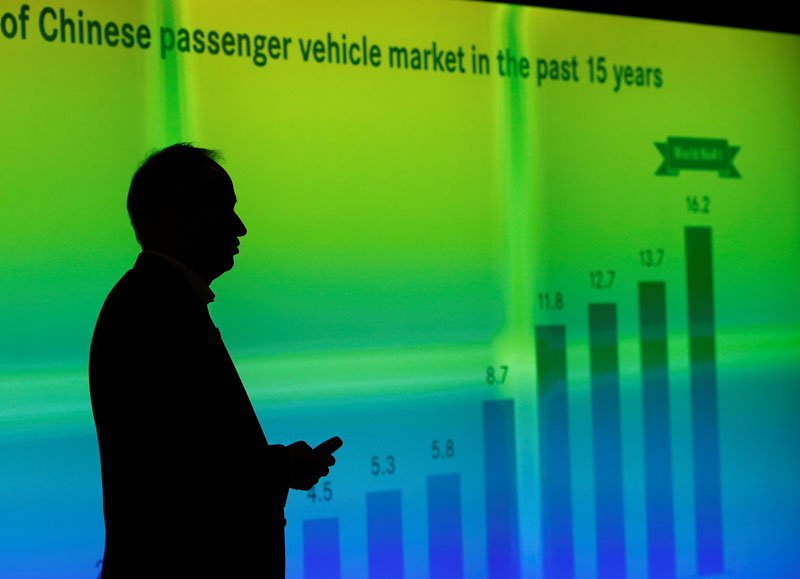 File- Hubertus Troska, chairman and chief executive officer of Daimler Greater China, is silhouetted against a screen showing a graph of Chinese passenger vehicle market in the past 15 years, as he speaks to reporters at the opening ceremony of the company's Mercedes-Benz research and development (R&amp;D) centre in Beijing November 3, 2014. Photo: REUTERS