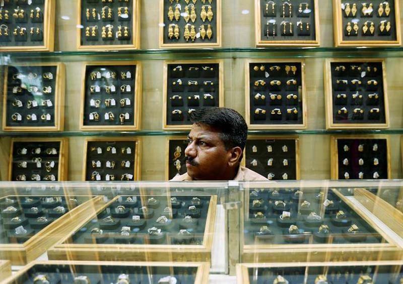 File- A salesman waits for customers inside a gold jewellery showroom in Mumbai, India, on May 9, 2016. Photo: Reuters
