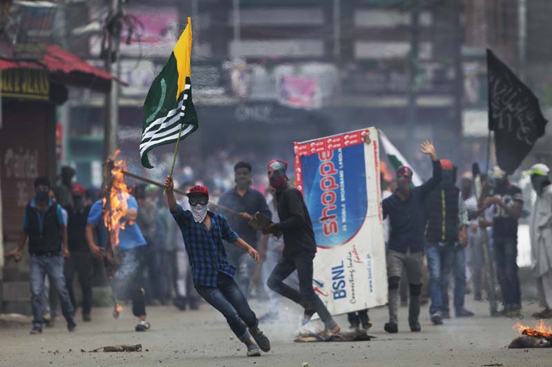 File-A Kashmiri protester holds a flag of Pakistan occupied Kashmir during a protest in Srinagar, Indian controlled Kashmir, on September 1, 2016. Photo: AP