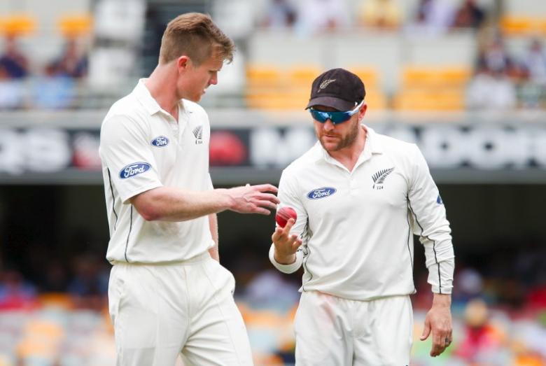 New Zealand bowler Jimmy Neesham (L) receives the ball from his captain Brendon McCullum during the first cricket test match between Australia and New Zealand in Brisbane November 6, 2015. REUTERS/Patrick Hamilton