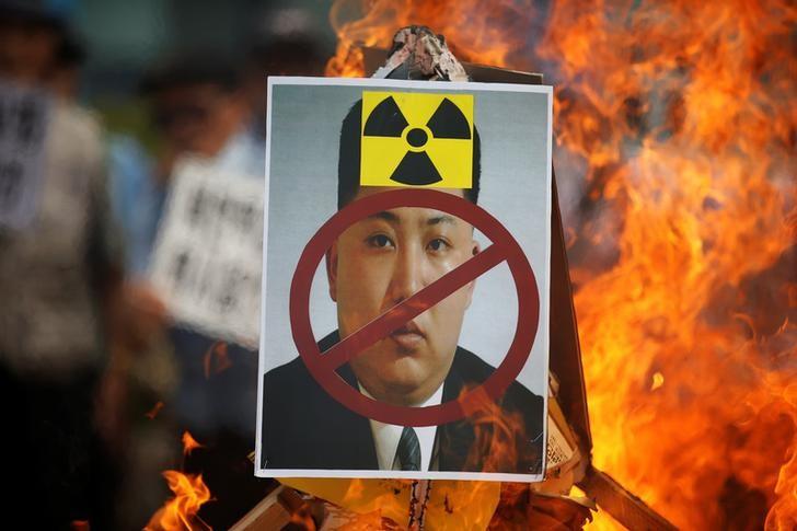A cut-out of North Korean leader Kim Jong Un is set on fire during an anti-North Korea rally in central Seoul, South Korea, September 10, 2016.  REUTERS/Kim Hong-Ji