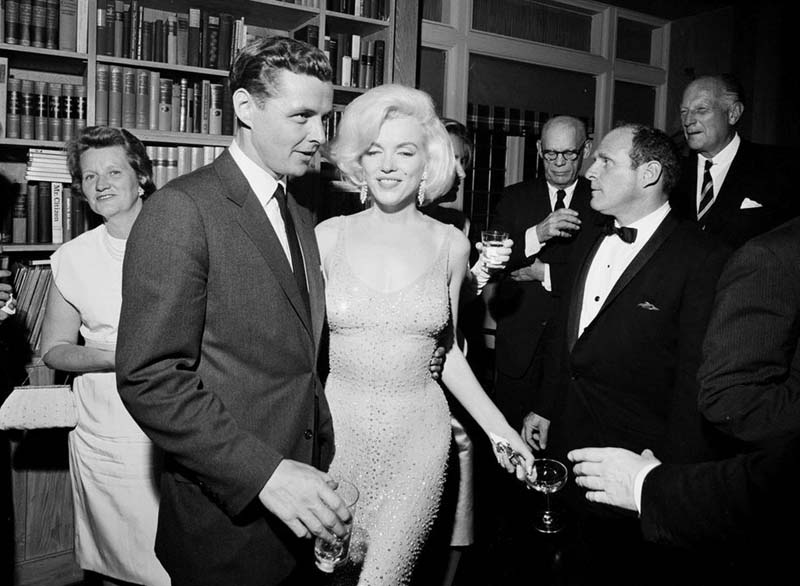 In this May 19, 1962 photo provided by the John F. Kennedy Presidential Library and Museum, actress Marilyn Monroe wears the iconic gown that she wore while singing u0093Happy Birthdayu0094 to President John F. Kennedy at Madison Square Garden, during a reception in New York City. Standing next to Monroe is Steve Smith, President John F. Kennedyu0092s brother-in-law. Julien's Auctions will offer Monroeu0092s gown at auction in Los Angeles on Nov. 17, 2016. The sultry actress wore the barely-there dress at Kennedy's 45th birthday celebration. (Cecil Stoughton/White House Photographs, John F. Kennedy Presidential Library and Museum via AP)