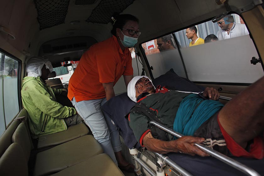 An injured person, rescued after an overcrowded bus slipped off a mountain road in Dhading is brought for treatment to the Teaching Hospital in Kathmandu, Nepal, Tuesday, Sept. 27, 2016. Photo: APn