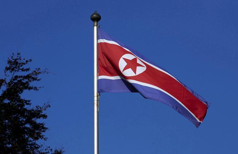 A North Korean flag flies on a mast at the Permanent Mission of North Korea in Geneva October 2, 2014. REUTERS/Denis Balibouse/Files