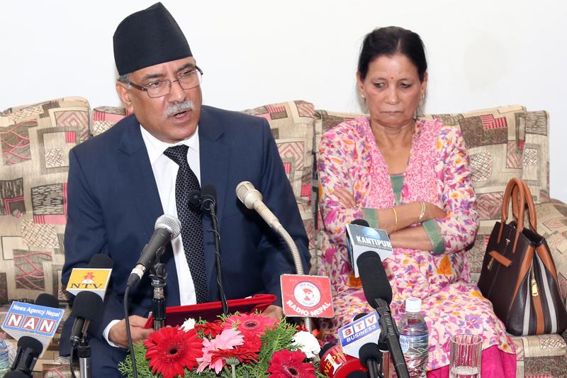 FILE: Accompanied by his wife Sita, Prime Minister Pushpa Kamal Dahal speaks with media as he arrives at the Tribhuvan International Airport, after concluding his state visit to India, on Sunday, September 18, 2016. Photo: RSS