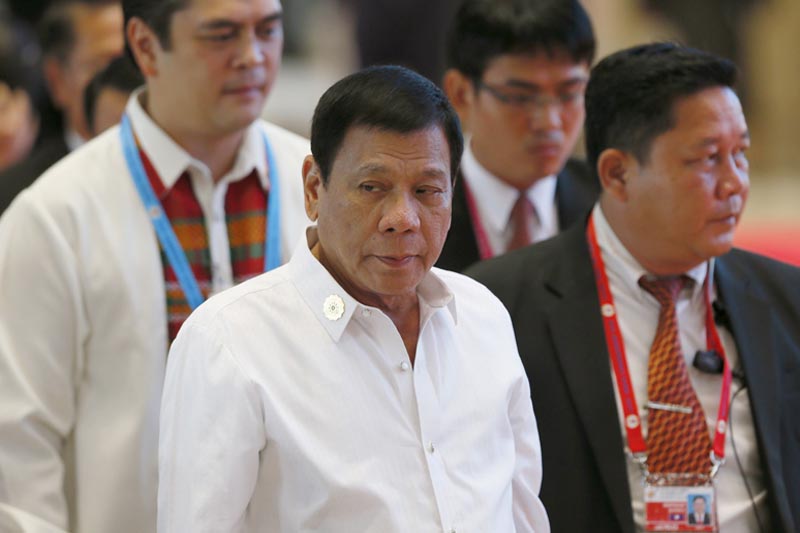 Philippine President Rodrigo Duterte (C) arrives at the National Convention Centre for scheduled bilateral meetings with ASEAN leaders on the sidelines of the 28th and 29th ASEAN Summits and other related summits, in Vientiane, Laos on Tuesday, September 6, 2016. Photo: AP