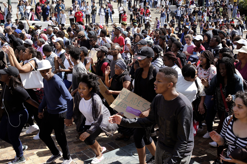 Students chant and sing at the University of Cape town as they protest for free education in Cape Town, South Africa, on Tuesday, September 20, 2016. Protesters also blocked entrances at the University of Cape Town, which has suspended classes on Tuesday and Wednesday because of the unrest. Photo: AP