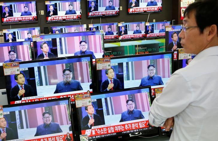 A sales assistant watches TV sets broadcasting a news report on North Korea's fifth nuclear test, in Seoul, South Korea, September 9, 2016.  REUTERS/Kim Hong-Ji