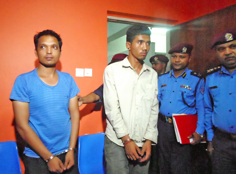 Bombers Handcuffed: Shankar Lakhe (left) and Chandra Bahadur Tamang being paraded at the Metropolitan Police Office in Ranipokhari. Photo: RSS