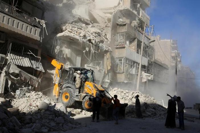 A front loader removes debris in a damaged site after airstrikes on the rebel held Tariq al-Bab neighbourhood of Aleppo, Syria September 24, 2016. REUTERS/Abdalrhman Ismail