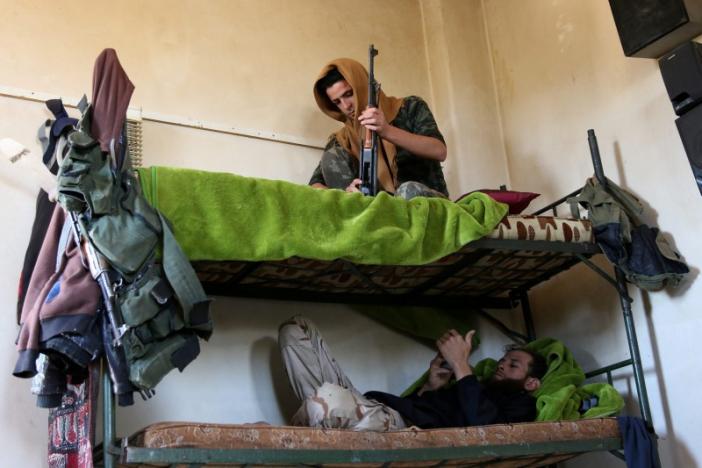 Rebel fighters rest on a double bed in Jubata al-Khashab, in Quneitra countryside, Syria September 11, 2016. REUTERS/Alaa Al-Faqir