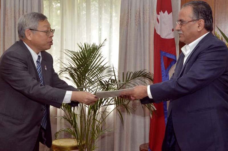 Thailand's Ambassador to Nepal Vutti Vuttisant (left) hands over an invitation to Prime Minister Pushpa Kamal Dahal to attend the second Asia Cooperation Dialogue (ACD) Summit in Thailand, at the latteru0092s official residence in Baluwatar, on Monday, September 5, 2016. Photo Courtesy: PMu0092s Secretariat