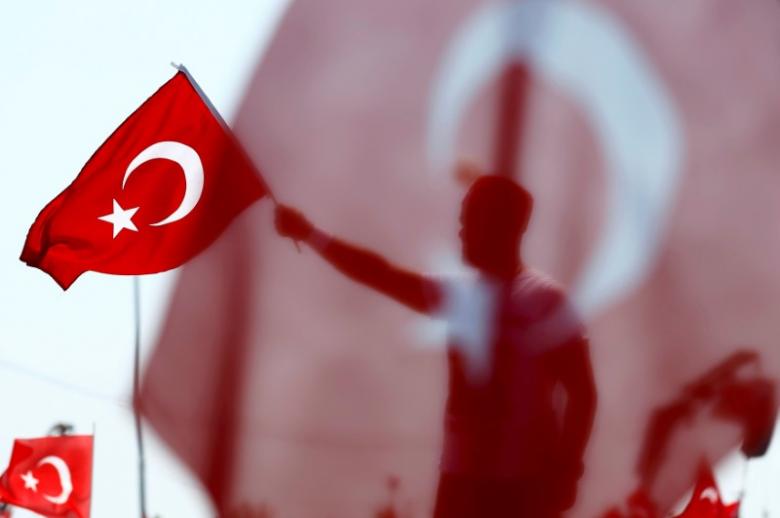 A man waves Turkey's national flag during the Democracy and Martyrs Rally, organized by Turkish President Tayyip Erdogan and supported by ruling AK Party (AKP), oppositions Republican People's Party (CHP) and Nationalist Movement Party (MHP), to protest against last month's failed military coup attempt, in Istanbul, Turkey, August 7, 2016. REUTERS/Umit Bektas