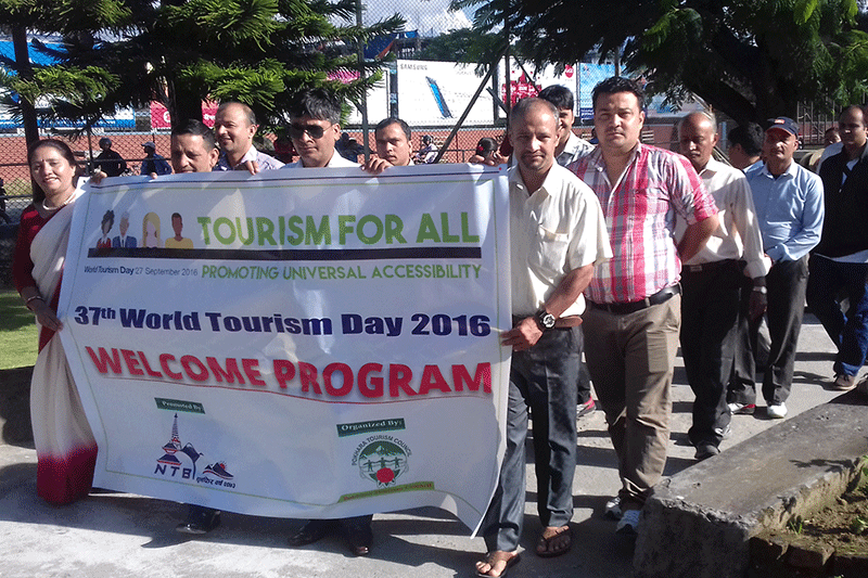 Pokhara tourism entrepreneurs with a banner reach Pokhara Airport to welcome tourists on the occasion of 37th World Tourism Day 2016 in Pokhara on Tuesday, September 27, 2016. Photo: RSS 