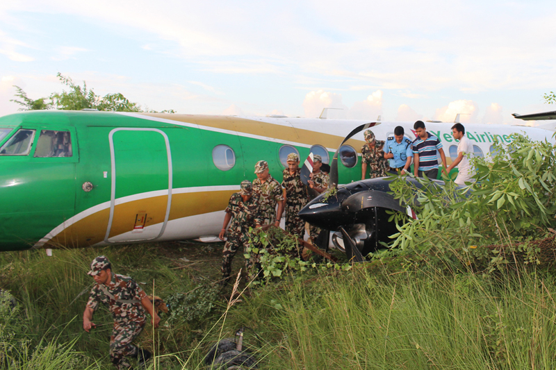 Security personnel take stock of the situation after a Yeti Airlines aircraft overshoots the runway of Bhairahawa Airport in Rupandehi, on Saturday, September 24, 2016. Photo: RSS
