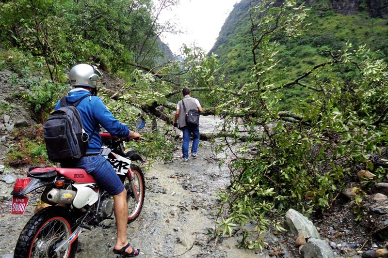 A motorcyclist is stranded as a landslide obstructs the Beni-Jomsom road section, in Myagdi district on Saturday, September 3, 2016. Photo: RSS