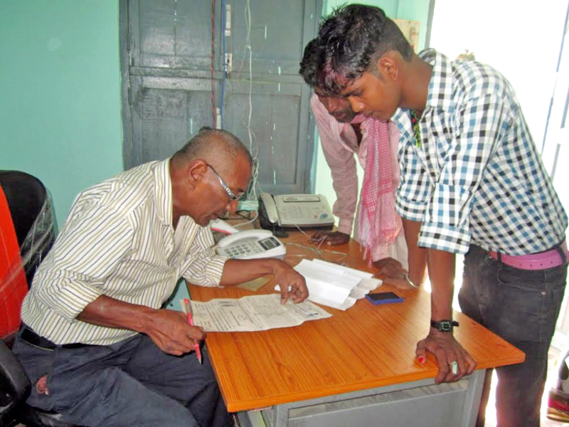 An official inspecting documents submitted by service seekers at Area Administration Office, in Bode Barsain, Saptari, on Friday, October 21, 2016. Photo: THT
