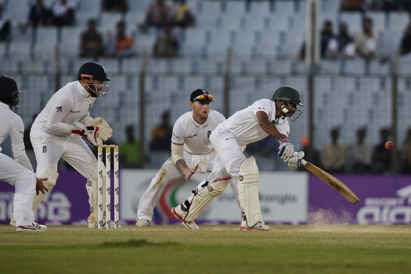 Bangladesh's Taijul Islam, right, plays a shot, as England's wicketkeeper Jonny Bairstow, second left, and Ben Stokes, watch during the fourth day of their first cricket test match in Chittagong, Bangladesh, Sunday, Oct. 23, 2016. Photo: AP