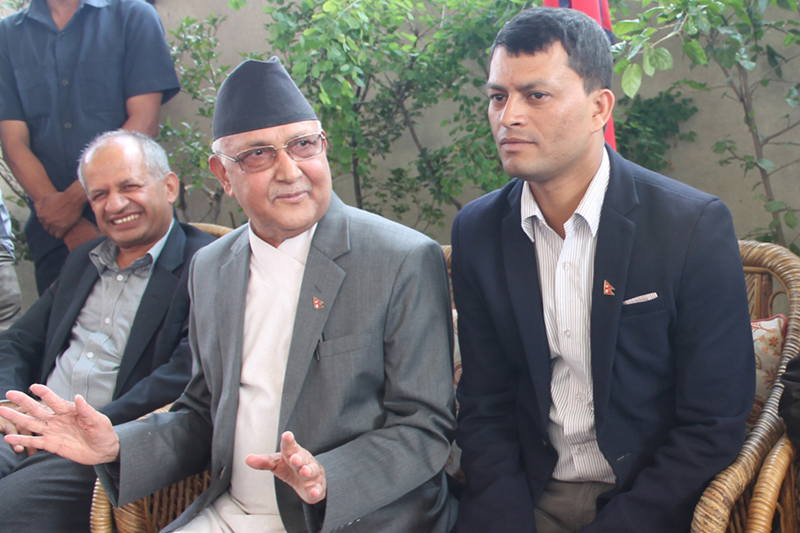CPN-UML Chairman KP Sharma Oli (centre) speaks to media at a Dashain greeting exchange programme at his residence in Balkot, on Saturday, October 08, 2016. Photo: RSS