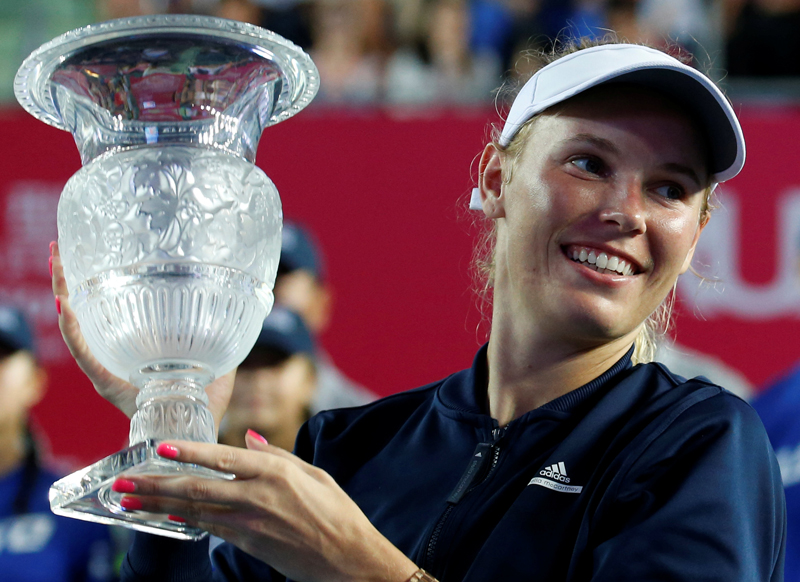 Wozniacki celebrates with trophy. Photo: Reuters