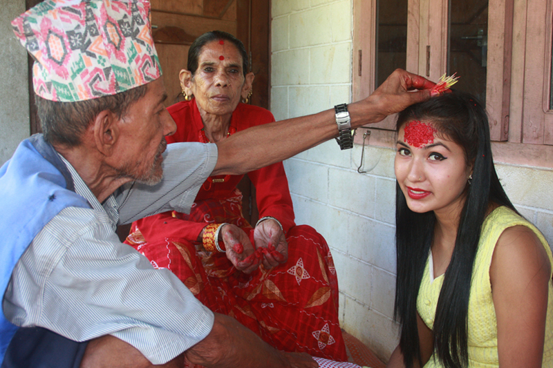 A girl receives Dashain Tika from her senior family members in Shaktikhor of Chitwan, on Tuesday, October 11, 2016. Photo: RSS