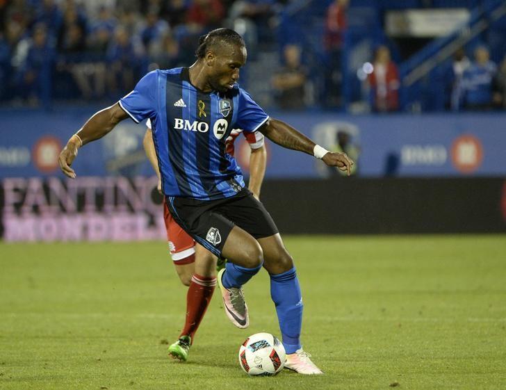 Sep 17, 2016; Montreal, Quebec, CAN; Montreal Impact forward Didier Drogba (11) dribbles the ball during the second half against the New England Revolution at Stade Saputo. Mandatory Credit: Eric Bolte-USA TODAY Sports